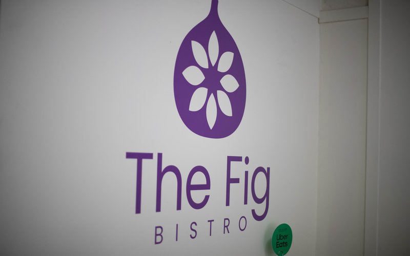 The Fig Bistro purple fig logo on the wall of the downtown Vernon café