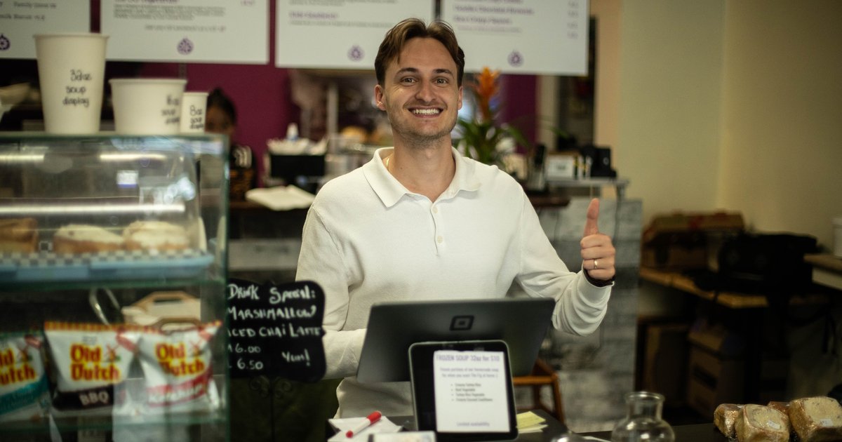 The Fig owner David Scarlatescu smiling behind the counter of his downtown Vernon café