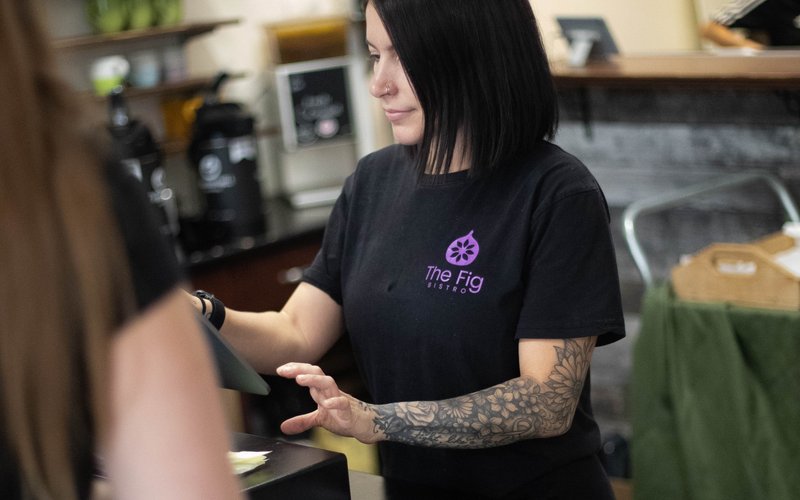 The Fig staff member serving a customer at the counter in downtown Vernon