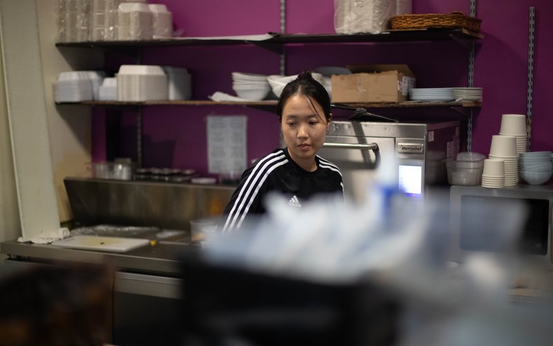 A Fig team member preparing food in the kitchen at the downtown Vernon café