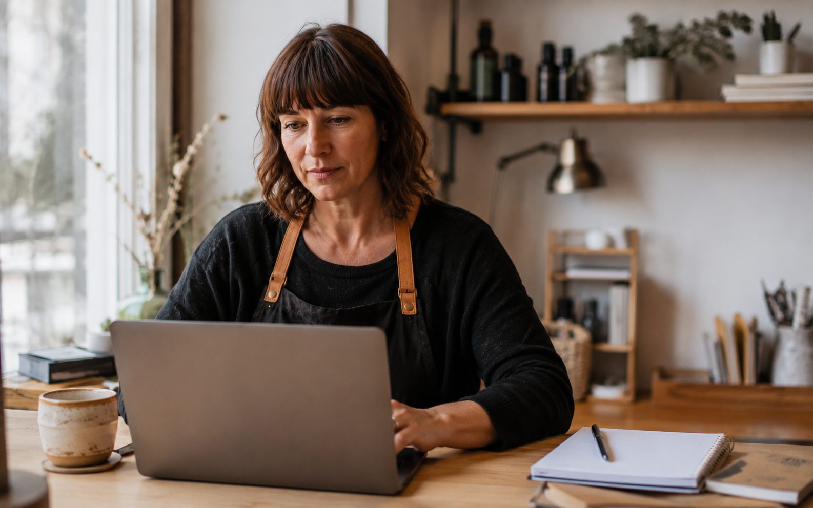 Vernon business owner replying to Google reviews on a laptop at their desk