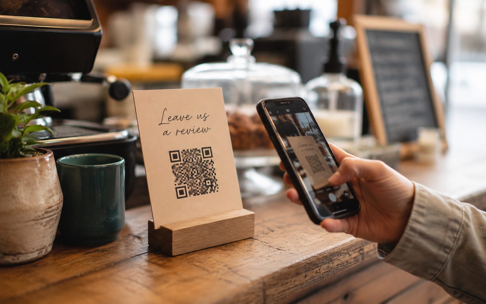 Google review QR code card on a Vernon café counter beside the till