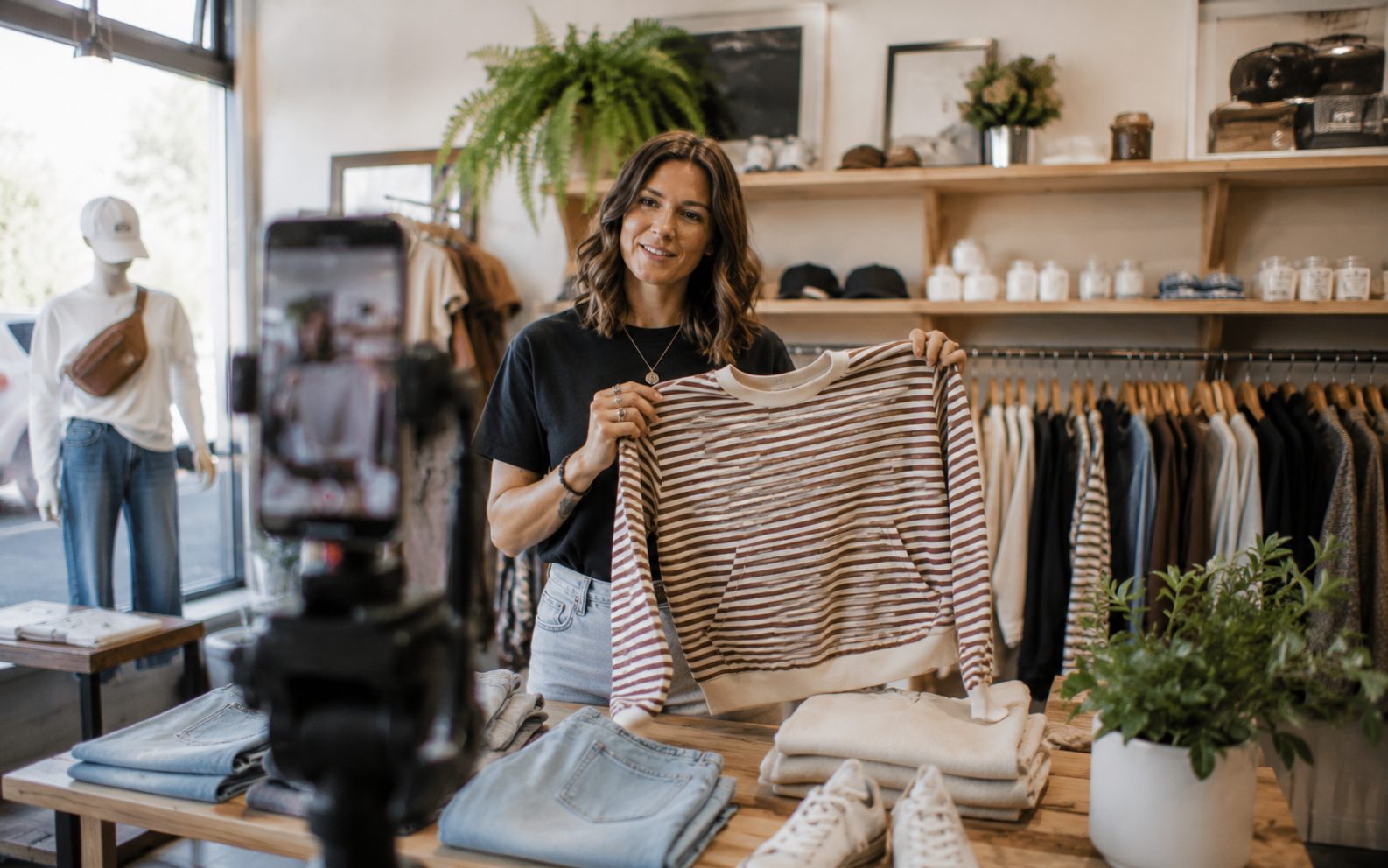 Vernon BC boutique owner presenting a product to camera for a short marketing video